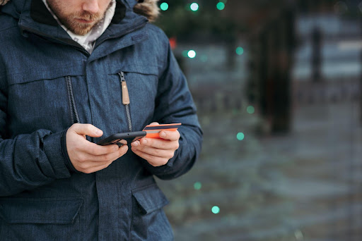 Photo by Anete Lusina: https://www.pexels.com/photo/man-browsing-smartphone-and-holding-credit-card-on-street-6353675/
